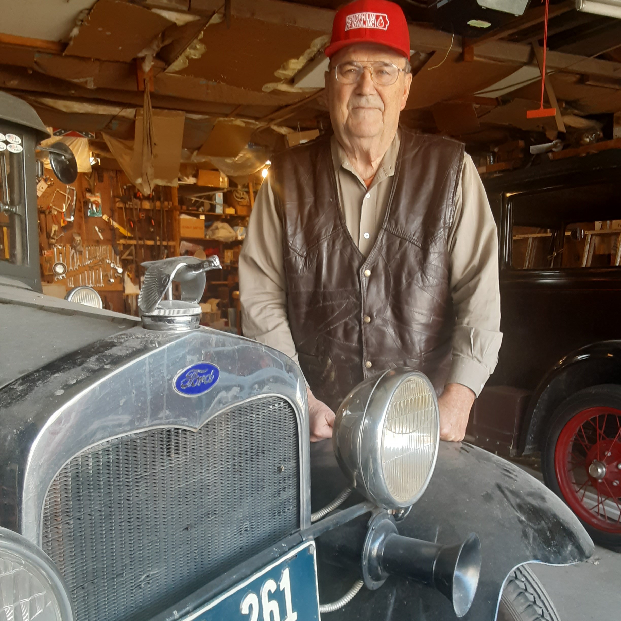 Dave Berkemann poses with one of his classic cars