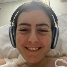 Lea Jabre listens to music while waiting in the hospital for a treatment for her stiff person syndrome.