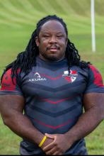 Ike posing in front of a grass field