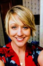 Heather Stewart selfie in a red and black blouse